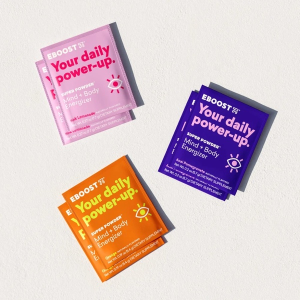 A high-contrast, top-down flat lay featuring three brightly colored dietary supplement sachets arranged on a clean, neutral background.